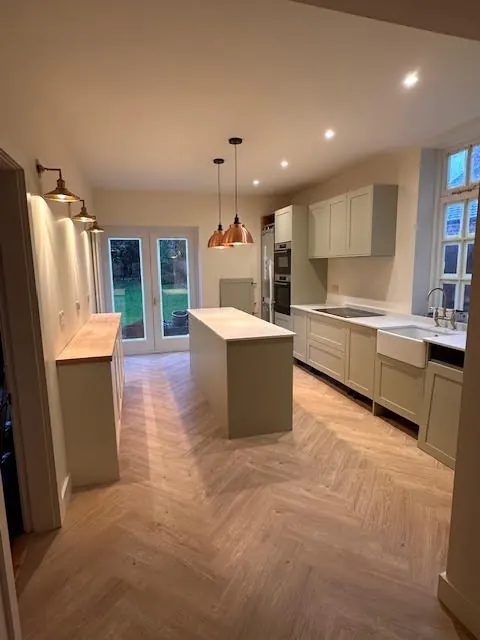 Open-plan kitchen extension with island and herringbone floor
